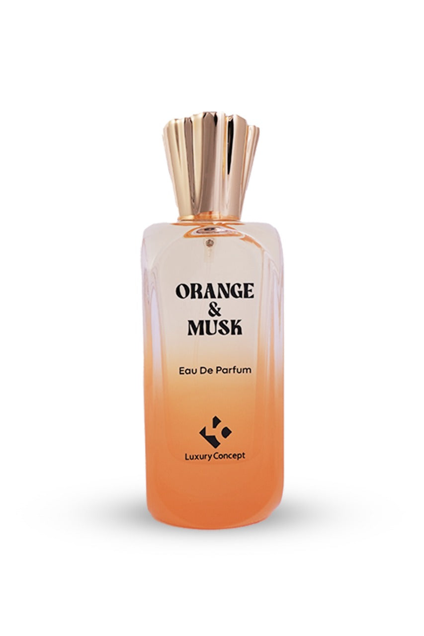 A bottle of 'Luxury Concept Orange & Musk' eau de parfum with a wooden diffuser stopper on top, indicating the fragrance notes of clementine, neroli, and driftwood.