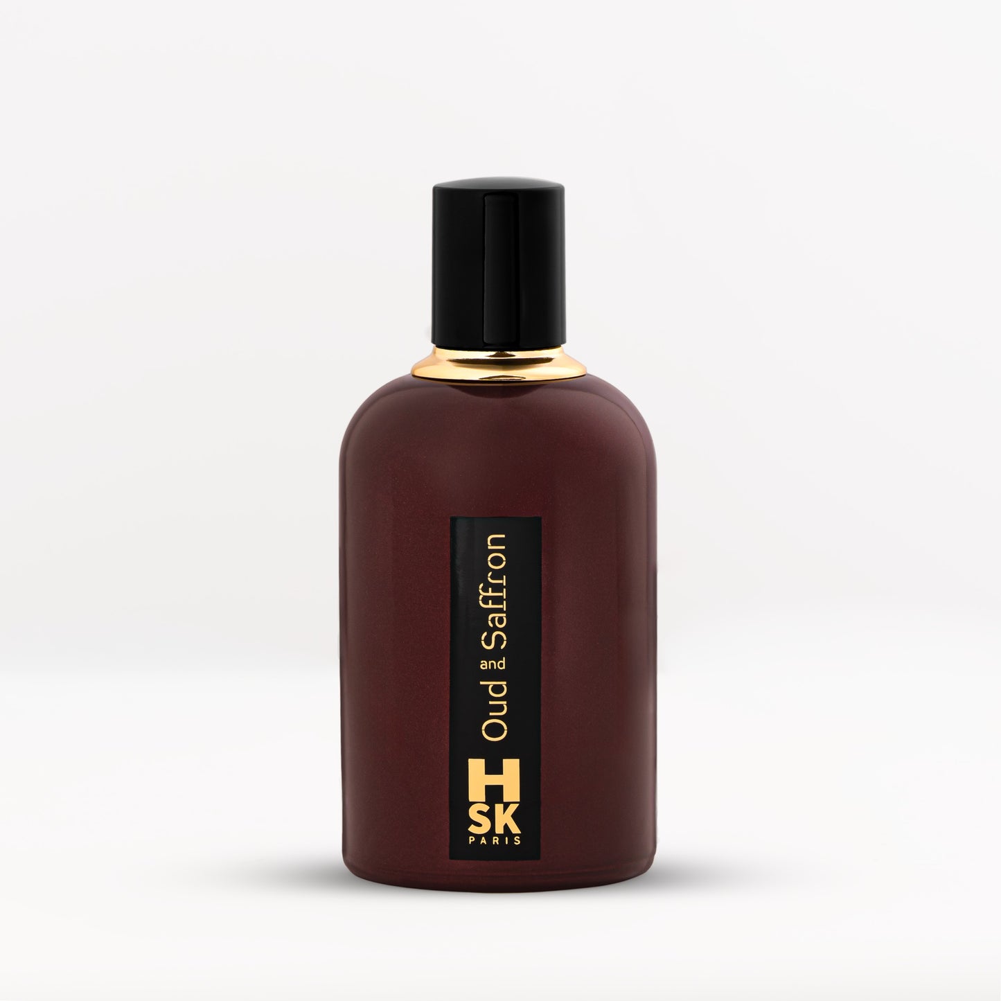 Dark purple Oud & Saffron extrait de parfum bottle with bold black cap and gold lettering, reflecting rich oud and warm saffron spice character.