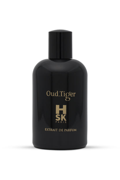 A black bottle of Oud Tiger perfume with gold text indicating the brand and name, with a white label underneath.