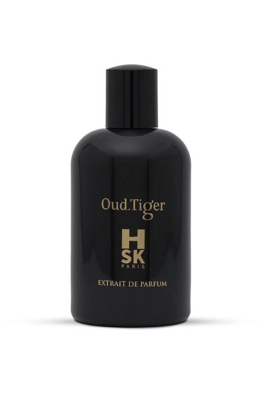 A black bottle of Oud Tiger perfume with gold text indicating the brand and name, with a white label underneath.