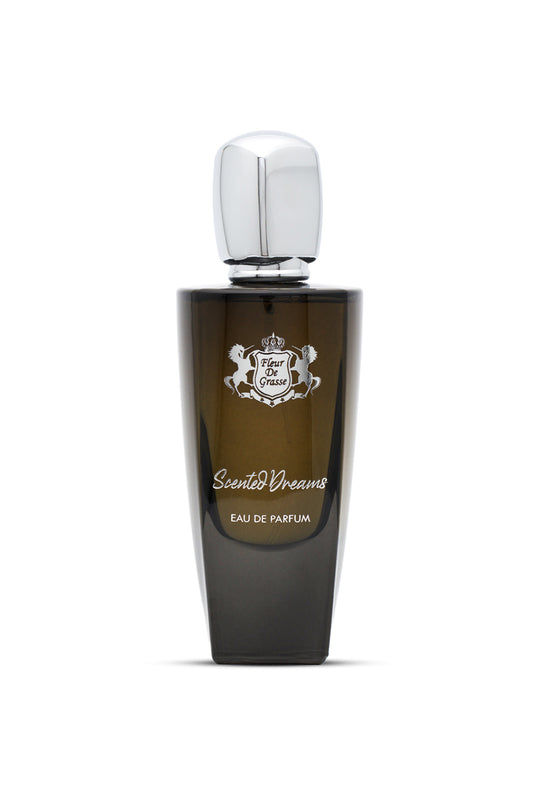 A dark glass bottle of SCENTED DREAMS EAU DE PARFUM with a silver cap and white label featuring elegant typography.